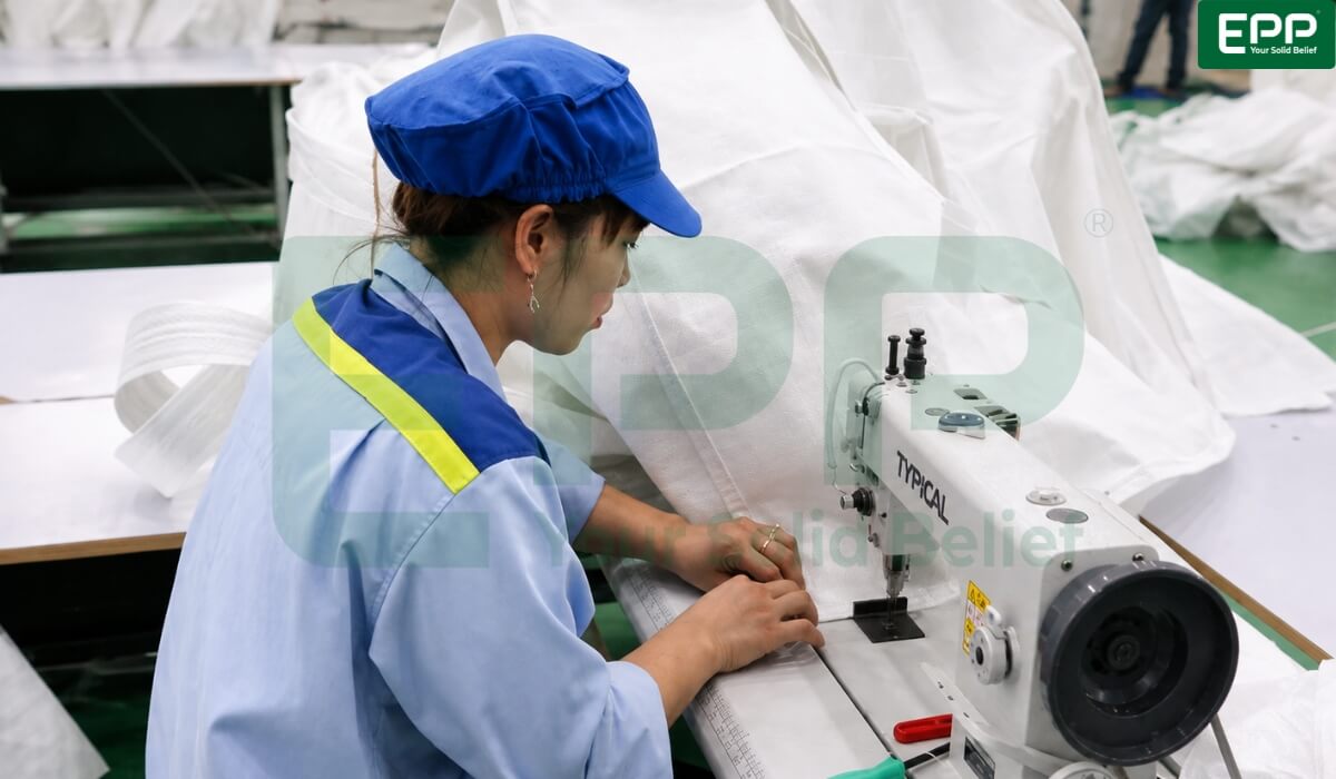 PP Vietnam production cleanroom with workers stitching compliant safety labels on Type C static protective FIBCs